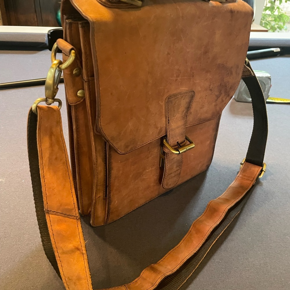 Brown leather satchel with shoulder strap. 12x11x2-4”